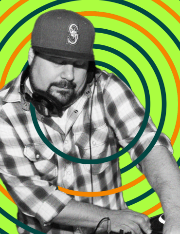 DJ Tamm t plays while holding headphones in place with shoulder