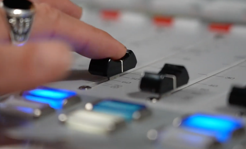 Close-up of person using mixing board