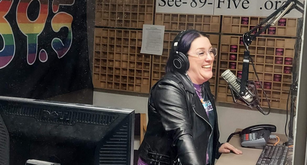 Harmony Soleil in a radio studio speaking on the mic while laughing