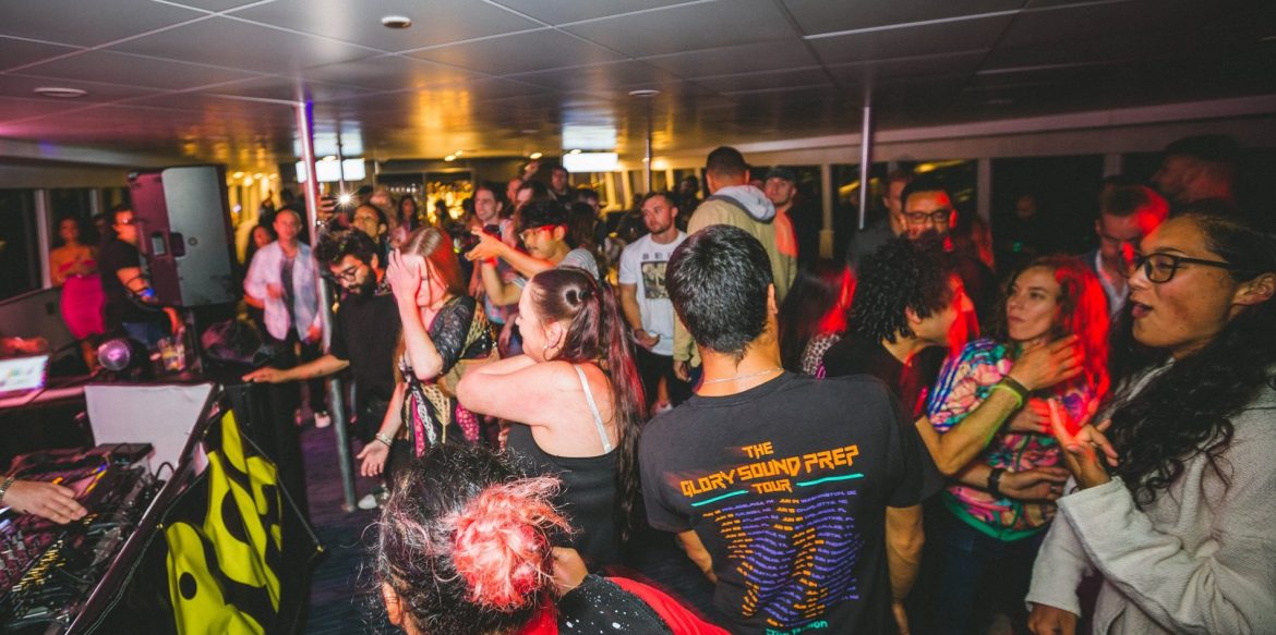 A crowded room filled with diverse people dancing
